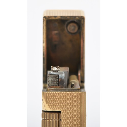 127 - Dunhill, a 9ct gold rollagas cigarette lighter, London 1967, with engine turned decoration, 105gm, o... 