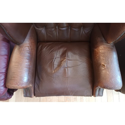 338 - A pair of Georgian style wingback armchairs, upholstered in tan leather with buttoned backs, raised ... 