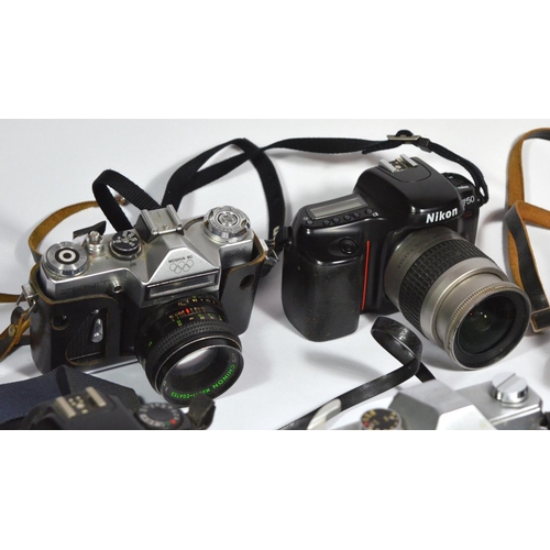 49 - Six 35mm film cameras, with lens, to include a Canon EOS 3000, a Praktica LTL-3, a Canon EOS1000F N,... 