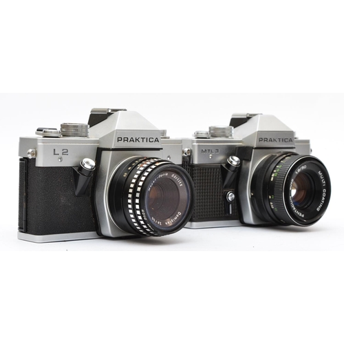 131 - A Praktica L2 35mm film camera, with a Meyer Optik 50mm f2.8 lens, cased, together with a Praktica M... 