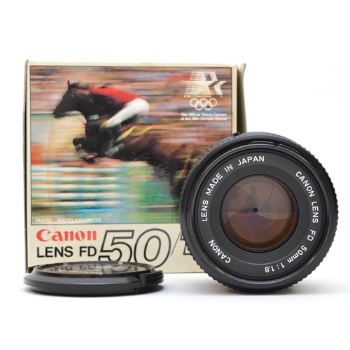 198 - A Canon FD 50mm f1.8 lens, original 1984 LA Olympics branded box, working with faint haze in the len... 