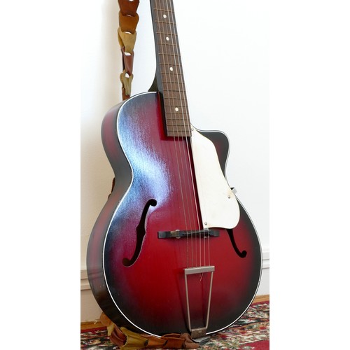 266 - A unbranded acoustic guitar, red sunburst colourway with white scratch guard, twin f-holes, leather ... 