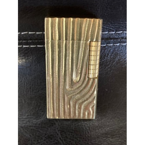 335 - A Dunhill 70 pocket cigarette lighter, gold plated with bark effect decoration.