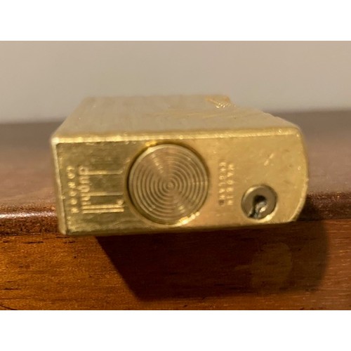 335 - A Dunhill 70 pocket cigarette lighter, gold plated with bark effect decoration.