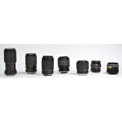 48 - Seven manual camera lenses, to include an Optomax 35mm f2.8, a Telsar 28mm f2.8, a Sigma 35mm-70mm f... 