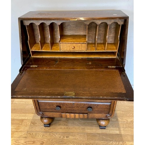 52 - A 1950s Art Deco inspired oak bureau, the hinged writing slope opening to reveal inset leather skive... 