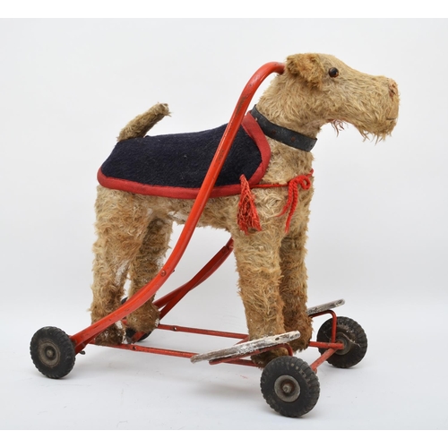 359 - A ride on push along child's toy, in the form on a dog, westie, with collar and jacket, with wooden ... 