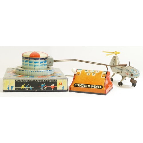 376 - A Biller tinplate remote controlled helicopter, made in Germany, transporter helicopter orbiting a a... 