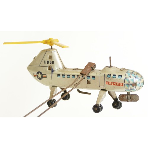 376 - A Biller tinplate remote controlled helicopter, made in Germany, transporter helicopter orbiting a a... 