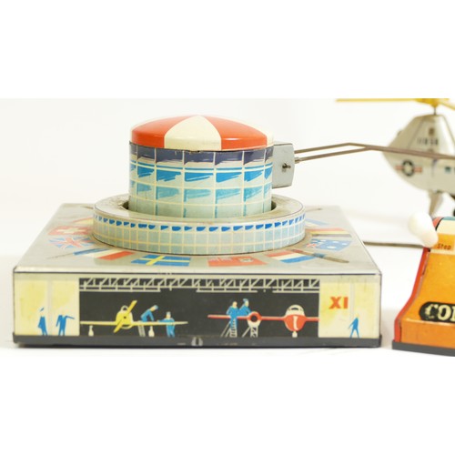 376 - A Biller tinplate remote controlled helicopter, made in Germany, transporter helicopter orbiting a a... 