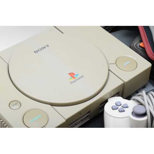 398 - A Sony Playstation (serial No B3278986), with power and AV cables, Dualshock controller (from a PS o... 