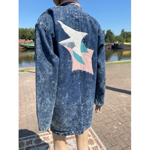 1980s vintage fashion, stonewashed long denim jacket with leather, applique and rhinestone embellishments, size large.
*Dummies, hats and props not included in the lot.