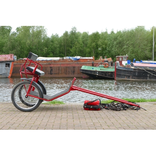 151 - A red painted horse/pony exercise cart, with English leather harness