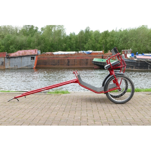 151 - A red painted horse/pony exercise cart, with English leather harness