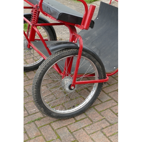 151 - A red painted horse/pony exercise cart, with English leather harness