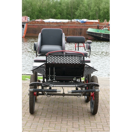 152 - A four wheel carriage, recently repainted, with 23