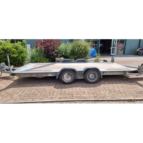 155 - A Brian James twin axel car trailer, 1600kg load, with pull out ramps and locking tow hitch with win... 