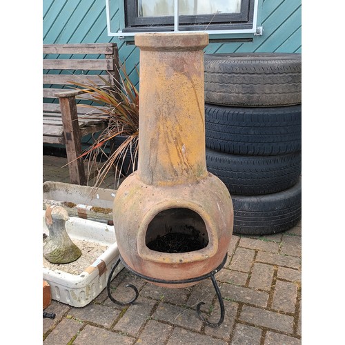 24 - A terracotta garden chiminea, together with a Belstaff sink, and a garden planter. Not the plant or ... 