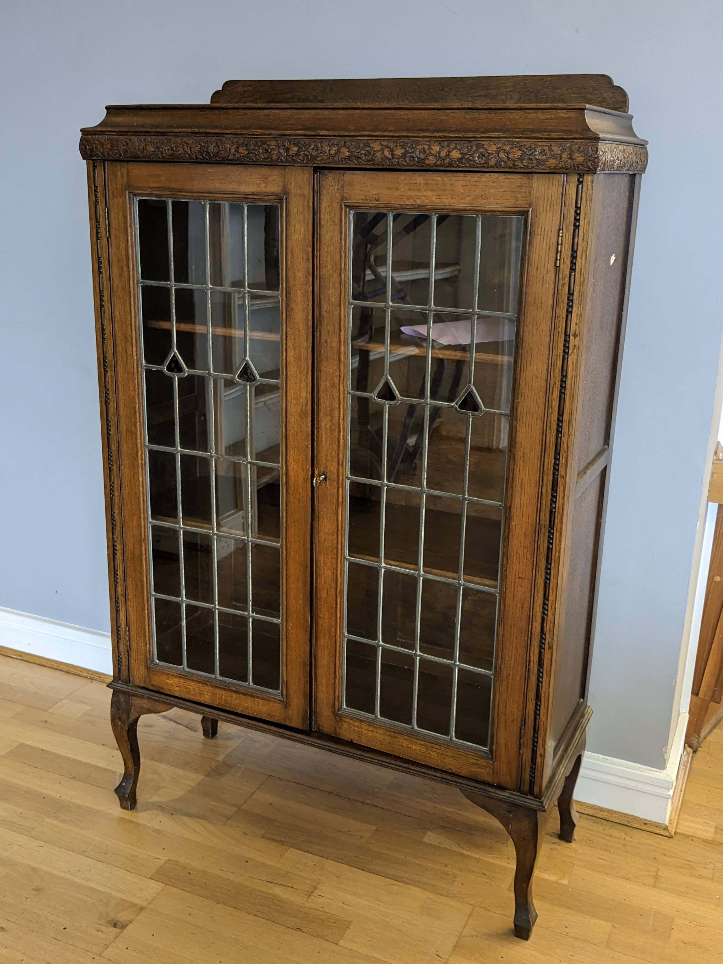 Antique curio cabinet with store leaded glass