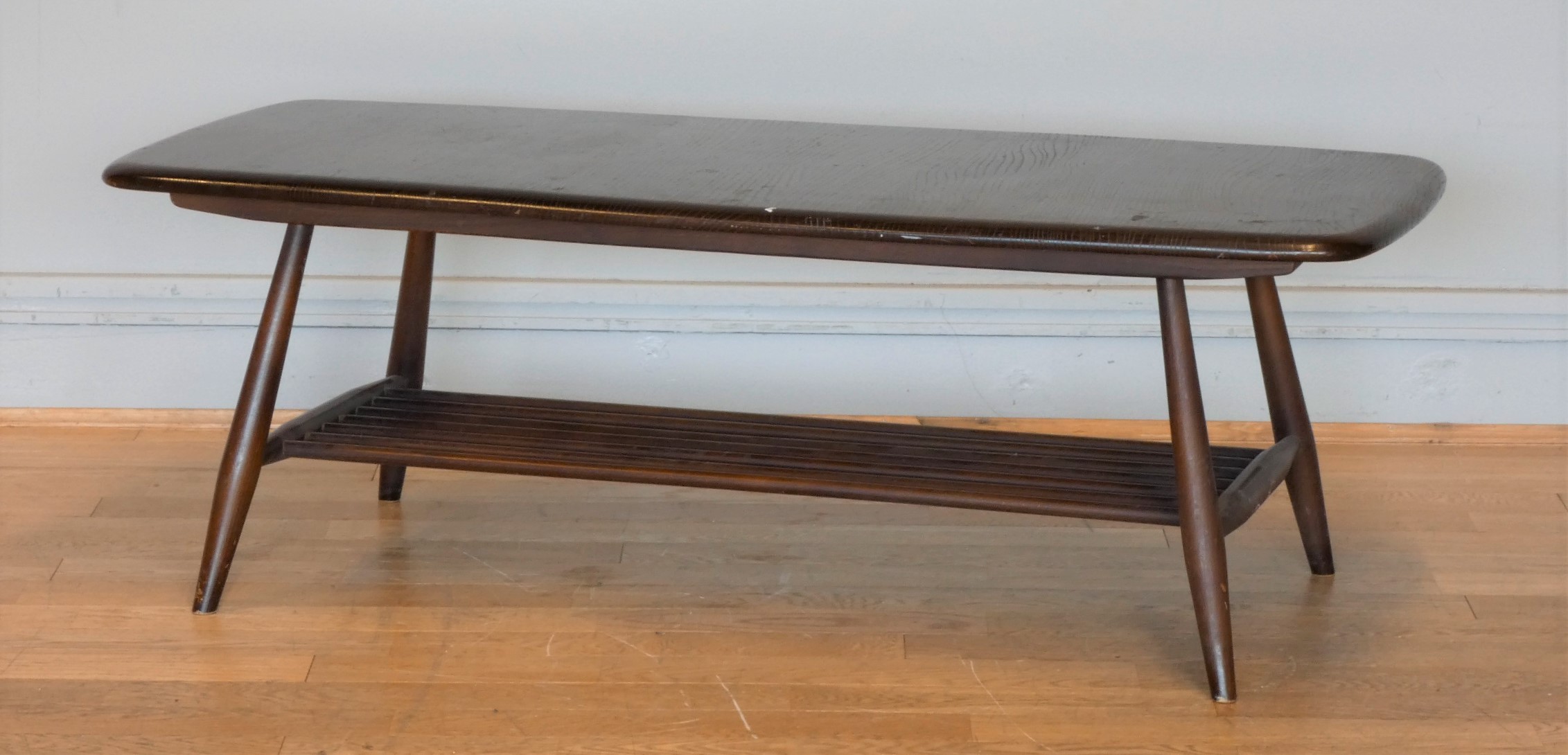 A 1960's Ercol occasional table, with slated under shelf on spayed legs ...