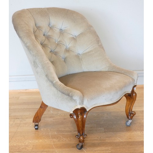 A Victorian nursing style arm chair walnut framed low arm rest button backed upholstered in grey