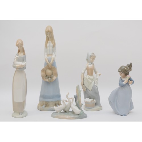 Four Nao figures, including a lady with duck (beak damaged), washer ...