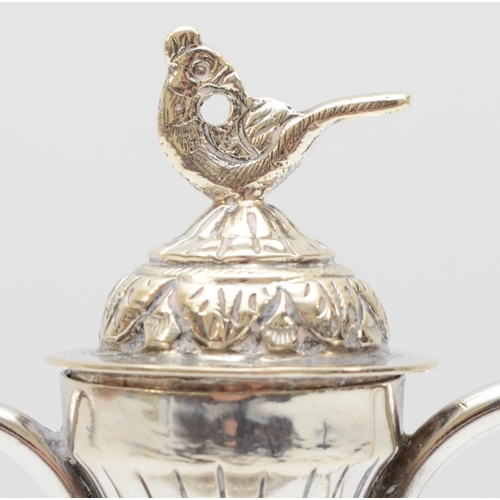 22 - An Indian silver long spout pot, stamped 925, with embossed and chased decoration, 13.5cm 199gm