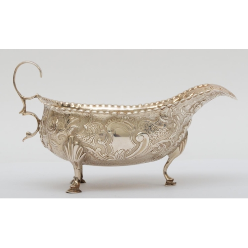 64 - A George III silver sauce boat, By Peter and Ann Bateman, London 1791, later embossed and chased wit... 