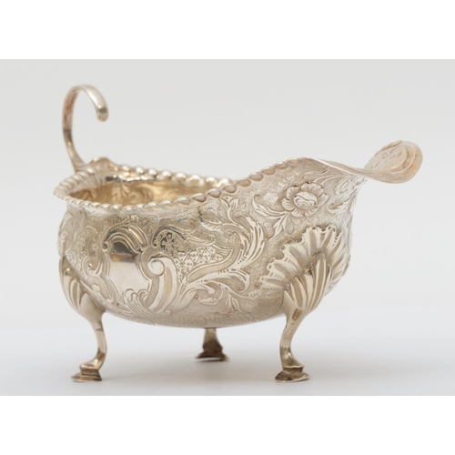 64 - A George III silver sauce boat, By Peter and Ann Bateman, London 1791, later embossed and chased wit... 