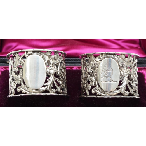 50 - A Victorian silver pair of napkin rings, Sheffield 1895, with pierced and embossed floral decoration... 