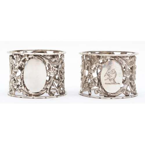 50 - A Victorian silver pair of napkin rings, Sheffield 1895, with pierced and embossed floral decoration... 