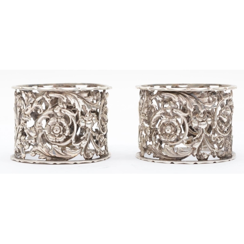 50 - A Victorian silver pair of napkin rings, Sheffield 1895, with pierced and embossed floral decoration... 