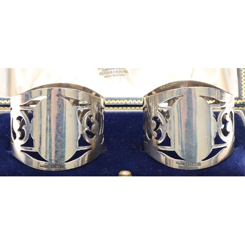 49 - A silver pair of napkin rings, Birmingham 1922, with pierced decoration, 41gm, cased