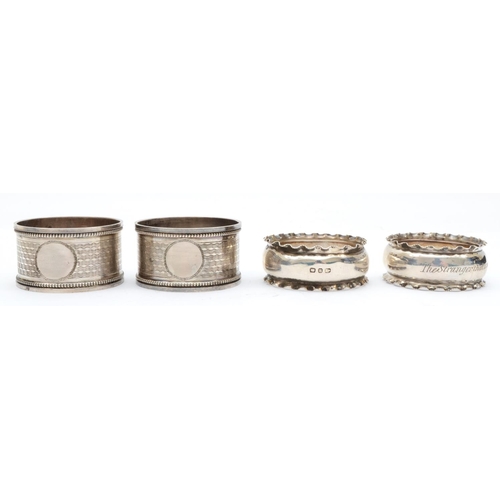 48 - A silver pair of napkin rings, Birmingham 1916, with engine turned decoration, 43gm, case and anothe... 