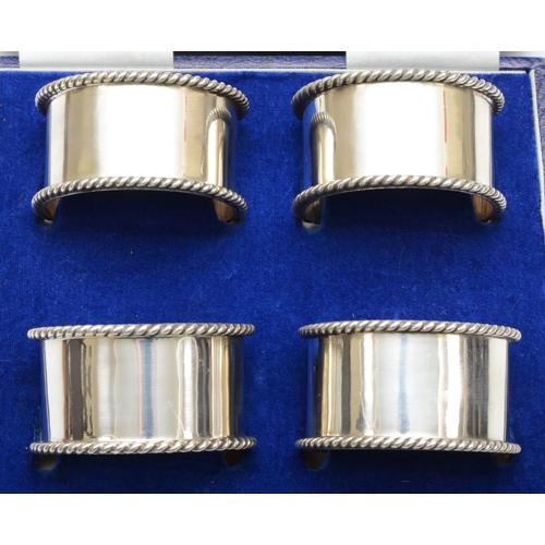 47 - A silver set of four semi circular napkin rings, Birmingham 1992, with rope twist border, 142gm, cas... 