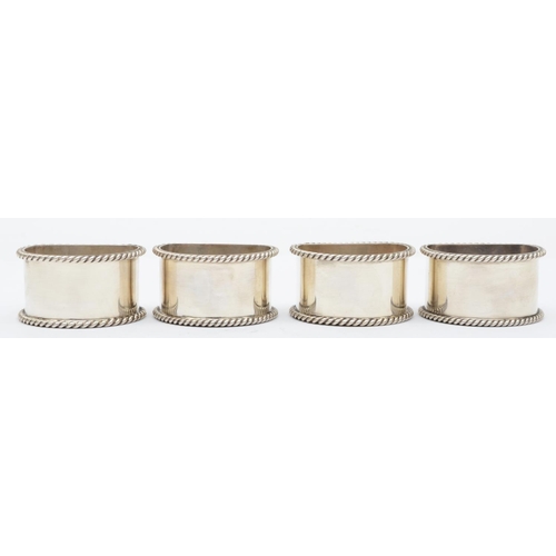 47 - A silver set of four semi circular napkin rings, Birmingham 1992, with rope twist border, 142gm, cas... 