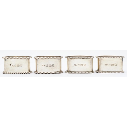 47 - A silver set of four semi circular napkin rings, Birmingham 1992, with rope twist border, 142gm, cas... 