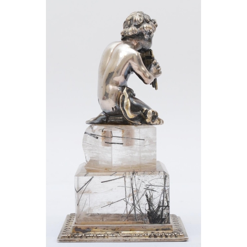 17 - A German 800 standard silver child playing a flute raised on a quartz pedestal with silver base, 9.5... 