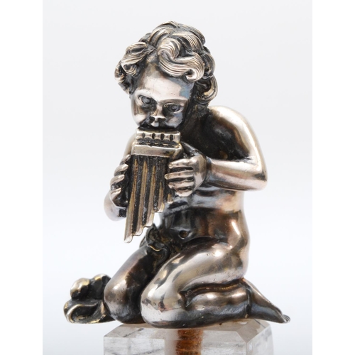 17 - A German 800 standard silver child playing a flute raised on a quartz pedestal with silver base, 9.5... 