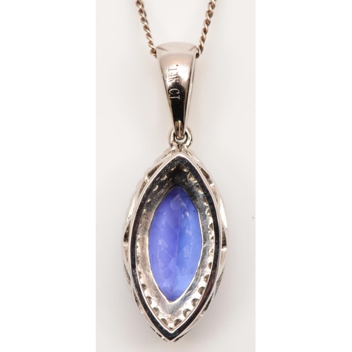 76 - A 14K white gold, tanzanite and brilliant cut diamond navette pendant, stone 11 x 6mm, of good colou... 