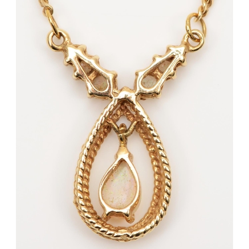 78 - A 14K gold and opal pendant, with articulated pear shape drop, 41cm, 6.5gm