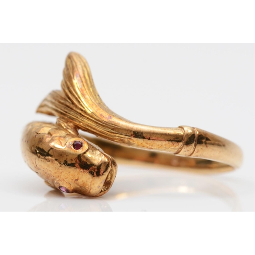 80 - An 18ct gold coiled fish ring, London 1977, lacking carat mark, with textured body and ruby eyes, P ... 