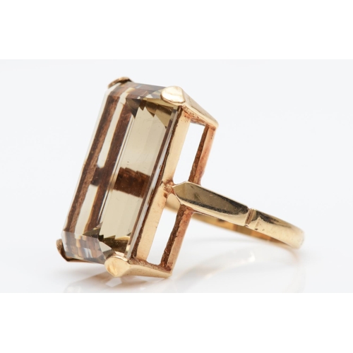 88 - A vintage 9ct gold and smokey quartz dress ring, stamped 9ct, claw set with an emerald cut stone mea... 