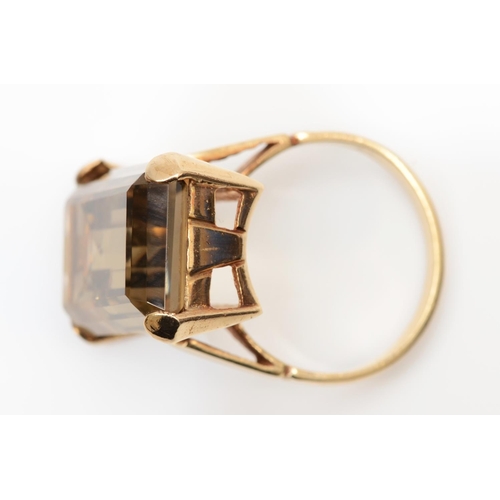 88 - A vintage 9ct gold and smokey quartz dress ring, stamped 9ct, claw set with an emerald cut stone mea... 