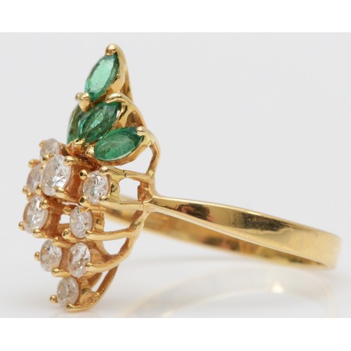 93 - A gold, emerald and diamond dress ring, stamped 750, claw set with brilliant cut stones, colour esti... 