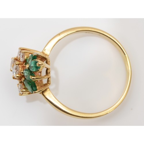 93 - A gold, emerald and diamond dress ring, stamped 750, claw set with brilliant cut stones, colour esti... 