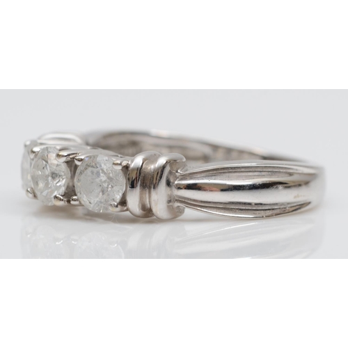 98 - A 14ct white gold and diamond three stone ring, claw set with brilliant cut stones, estimated to wei... 