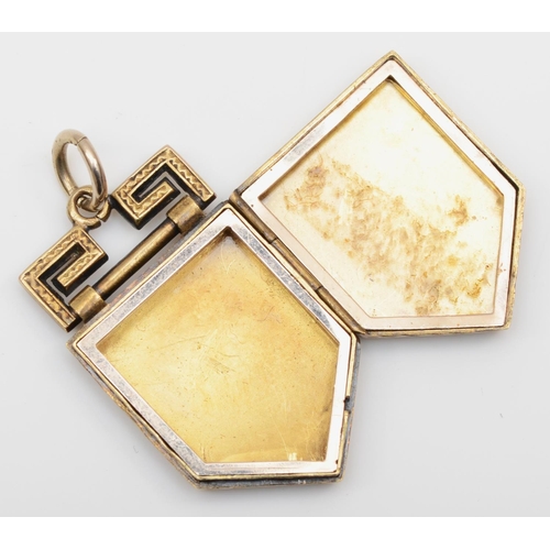 108 - A Victorian gold cased shield shape locket, metal frame, with engraved decoration, 27 x 17mm