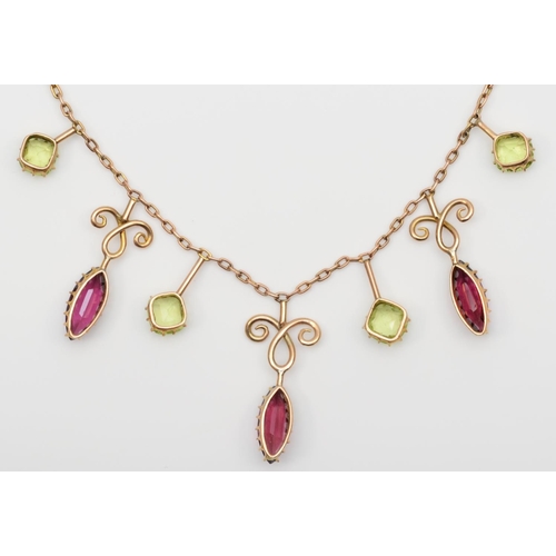 113 - An Edwardian rose gold almandine garnet and peridot fringe necklace, unmarked, 42cm, 7.2gm