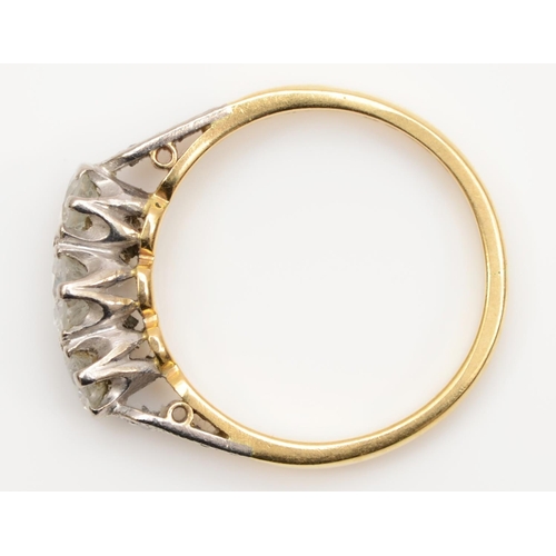 114 - An 18ct gold three stone diamond ring, London 1976, claw set with brilliant cut stones, approximatel... 